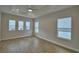 Bedroom features multiple windows, wood-look floors, and recessed lighting at 2673 Calistoga Ave, Kissimmee, FL 34741