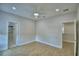 Open bedroom with light wood floors, ceiling fan, recessed lighting, and bathroom access at 2673 Calistoga Ave, Kissimmee, FL 34741