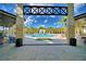 Framed view of a community pool featuring an intricate design, with ample seating, and palm trees at 2673 Calistoga Ave, Kissimmee, FL 34741