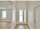 Bright foyer featuring wood-look flooring, and large windows with an interior view at 2673 Calistoga Ave, Kissimmee, FL 34741