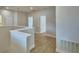 Bright upstairs hallway with wood flooring and white trim, leading to various rooms at 2673 Calistoga Ave, Kissimmee, FL 34741