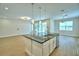 Bright, open kitchen with island, granite countertops and stainless steel appliances overlooking the dining and living area at 2673 Calistoga Ave, Kissimmee, FL 34741
