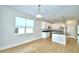 Open-concept kitchen features stainless steel appliances, a center island, and a view of the backyard at 2673 Calistoga Ave, Kissimmee, FL 34741