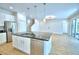 Modern kitchen island with a stainless steel dishwasher, sink, faucet and open floor plan for entertaining at 2673 Calistoga Ave, Kissimmee, FL 34741