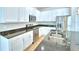 Close-up of a kitchen island with a stainless steel sink, faucet, and stainless steel appliances at 2673 Calistoga Ave, Kissimmee, FL 34741