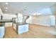 Modern kitchen with a center island, stainless steel appliances, white cabinetry, and an open layout at 2673 Calistoga Ave, Kissimmee, FL 34741