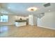 Spacious living room with recessed lighting, light wood floors, and an open kitchen with stainless steel appliances at 2673 Calistoga Ave, Kissimmee, FL 34741