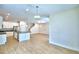 A bright and spacious area with modern light fixtures, wood floors, and seamless flow to the kitchen at 2673 Calistoga Ave, Kissimmee, FL 34741