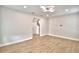 Open living area with light laminate flooring, recessed lighting, and neutral paint at 2673 Calistoga Ave, Kissimmee, FL 34741