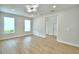 Bright living area featuring wood-look floors, recessed lights and access to additional rooms at 2673 Calistoga Ave, Kissimmee, FL 34741