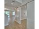 Open-concept living area with wood-look floors and modern sliding barn doors at 2673 Calistoga Ave, Kissimmee, FL 34741