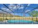Screened-in pool area featuring a black -safety fence and comfortable lounge chairs at 2673 Calistoga Ave, Kissimmee, FL 34741