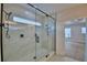 Modern bathroom featuring a luxurious glass shower with marble tile and black hardware at 2673 Calistoga Ave, Kissimmee, FL 34741