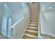 Bright staircase featuring natural wood steps and white risers leading to the upper level at 2673 Calistoga Ave, Kissimmee, FL 34741