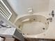Well-lit bathtub featuring jets for a spa-like experience at 2807 Playing Otter Ct, Kissimmee, FL 34747