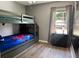 Cozy bedroom with bunk beds and a window offering natural light at 2807 Playing Otter Ct, Kissimmee, FL 34747