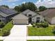 Charming single-Gathering home with a two-car garage, manicured lawn, and beautiful landscaping enhances curb appeal at 2807 Playing Otter Ct, Kissimmee, FL 34747