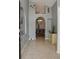 Inviting foyer with tile flooring, arched doorways, and decorative wall art leading into the dining area at 2807 Playing Otter Ct, Kissimmee, FL 34747