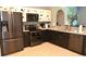 Kitchen showcases stainless steel appliances, dark countertops, and cabinetry with colorful polka dot accents at 2807 Playing Otter Ct, Kissimmee, FL 34747