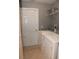 Functional laundry room featuring a washer, dryer, and shelving for storage at 2807 Playing Otter Ct, Kissimmee, FL 34747
