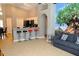 Open-concept living area featuring a breakfast bar with seating and a decorative tree mural at 2807 Playing Otter Ct, Kissimmee, FL 34747