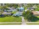 Aerial view of a well-maintained home, featuring a manicured lawn, mature trees, and a neatly paved driveway at 2830 W Oak St, Kissimmee, FL 34741