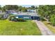 An aerial view displays the home's lush lawn and surrounding neighborhood at 2830 W Oak St, Kissimmee, FL 34741
