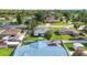 Quaint single-story home with a blue metal roof and mature trees in a residential neighborhood at 2830 W Oak St, Kissimmee, FL 34741