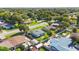 Neighborhood aerial showcasing tree coverage and the layout of houses, fences, and streets in a suburban area at 2830 W Oak St, Kissimmee, FL 34741