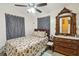 Cozy bedroom with a floral comforter, vintage dresser, and soft lighting creating a relaxing atmosphere at 2830 W Oak St, Kissimmee, FL 34741