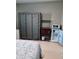 Bedroom with large portable closet, rolling rack with microwave, and mini refrigerator at 2830 W Oak St, Kissimmee, FL 34741
