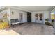 Covered entrance with decorative wreaths, an iron bench, and a smooth concrete floor at 2830 W Oak St, Kissimmee, FL 34741