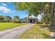 Well-kept single-story home with a covered carport, mature landscaping, and spacious front yard at 2830 W Oak St, Kissimmee, FL 34741