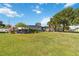 Single-story home with lush green lawn, mature trees, and blue sky background at 2830 W Oak St, Kissimmee, FL 34741