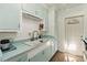 Quaint kitchen featuring light blue cabinetry, retro countertops, and lots of natural light at 2830 W Oak St, Kissimmee, FL 34741