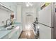 Charming kitchen with retro light-blue cabinets, white appliances, and a door leading to the outside at 2830 W Oak St, Kissimmee, FL 34741