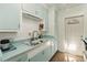 Bright kitchen featuring light blue countertops and cabinets, stainless steel faucet, and a sunny window at 2830 W Oak St, Kissimmee, FL 34741