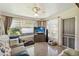 Cozy living room featuring a comfy sofa, a mounted television, and a screen door for easy outdoor access at 2830 W Oak St, Kissimmee, FL 34741