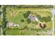 Aerial view of a landscaped property featuring a pool, grassy field and surrounding trees at 3181 Canter Ln, Kissimmee, FL 34746