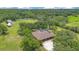 Aerial view of a home with a screened pool and surrounding lush landscaping at 3181 Canter Ln, Kissimmee, FL 34746