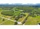 Extensive land featuring several homes, a mix of wooded areas, and expansive green fields, ideal for country living at 3181 Canter Ln, Kissimmee, FL 34746