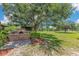 The spacious backyard features mature trees, an outdoor brick oven and green grass at 3181 Canter Ln, Kissimmee, FL 34746