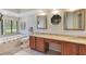 Bathroom featuring granite countertops, a soaking tub, and decorative mirrors at 3181 Canter Ln, Kissimmee, FL 34746
