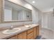 Bathroom with double sinks, granite countertops, and a large mirror at 3181 Canter Ln, Kissimmee, FL 34746