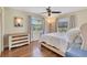 Bedroom with hardwood floors, two windows, a ceiling fan, and decor at 3181 Canter Ln, Kissimmee, FL 34746