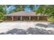 A single story home with a brick exterior, well manicured landscaping, and a large circular driveway at 3181 Canter Ln, Kissimmee, FL 34746