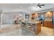 Bright kitchen with an island, granite countertops, a breakfast bar, stainless steel appliances, and modern finishes at 3181 Canter Ln, Kissimmee, FL 34746