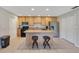 Bright kitchen with center island, wooden cabinets, tile floor, and modern appliances at 3181 Canter Ln, Kissimmee, FL 34746