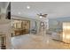 Open concept living room featuring tile flooring, modern furnishings, and fireplace at 3181 Canter Ln, Kissimmee, FL 34746