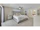 Bedroom featuring a tufted headboard, ceiling fan, and french doors to a side patio at 3181 Canter Ln, Kissimmee, FL 34746